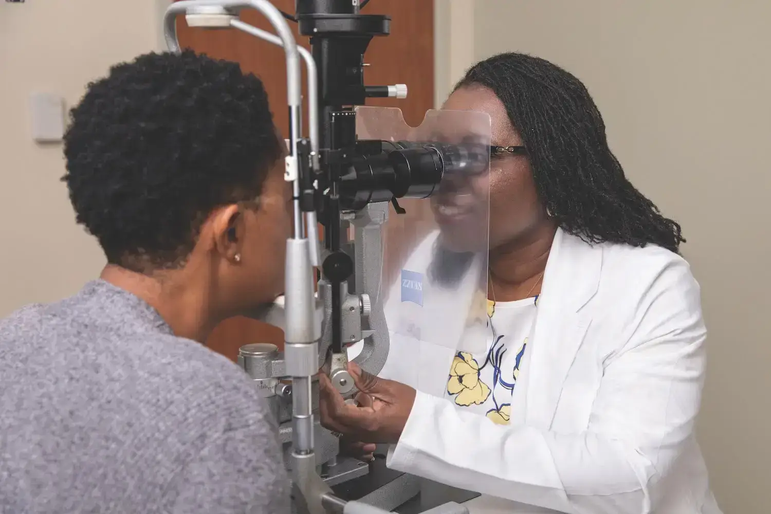 Dr. Okogbaa performing an eye exam on a patient